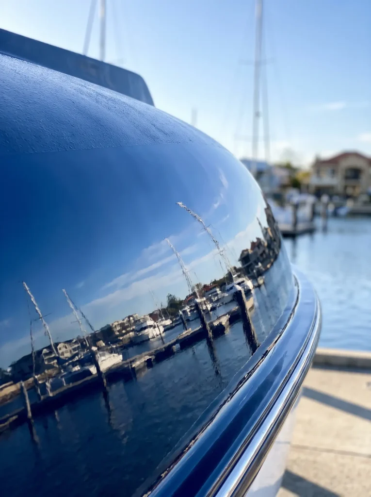 Navy boat hull restored to mirror gloss after oxidation removal in O'Connor WA