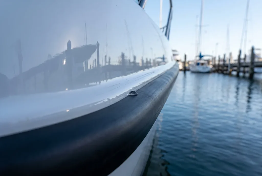 Ceramic coating edge detail on a glossy boat hull in O'Connor showing crisp coated-to-trim boundary line