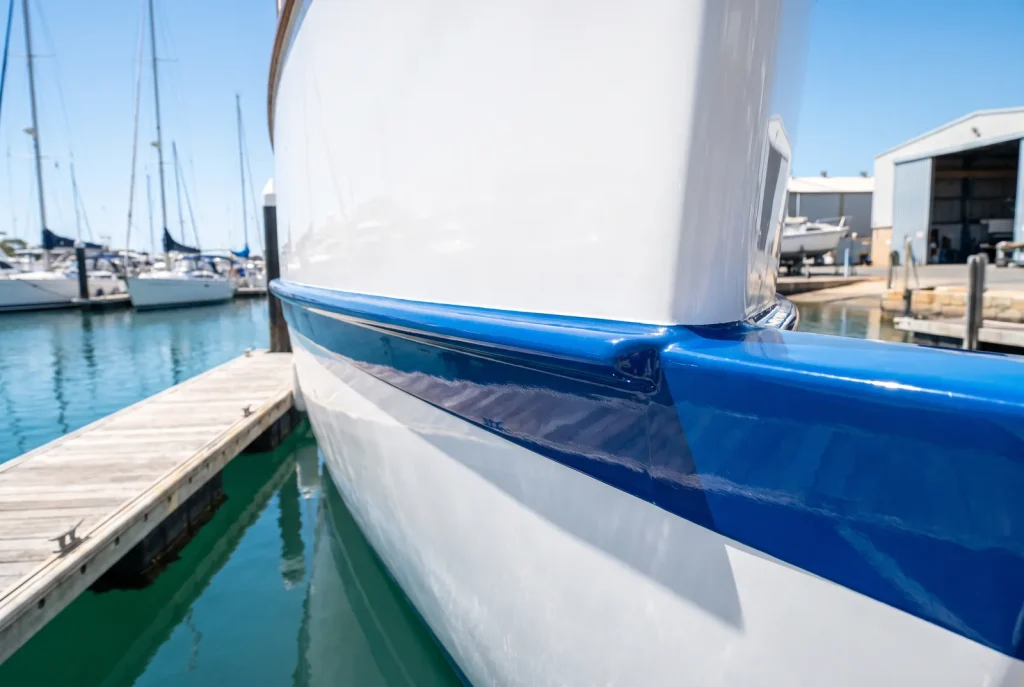 Crisp polished waterline seam on exterior detailed boat hull in O'Connor, WA boat detailing result