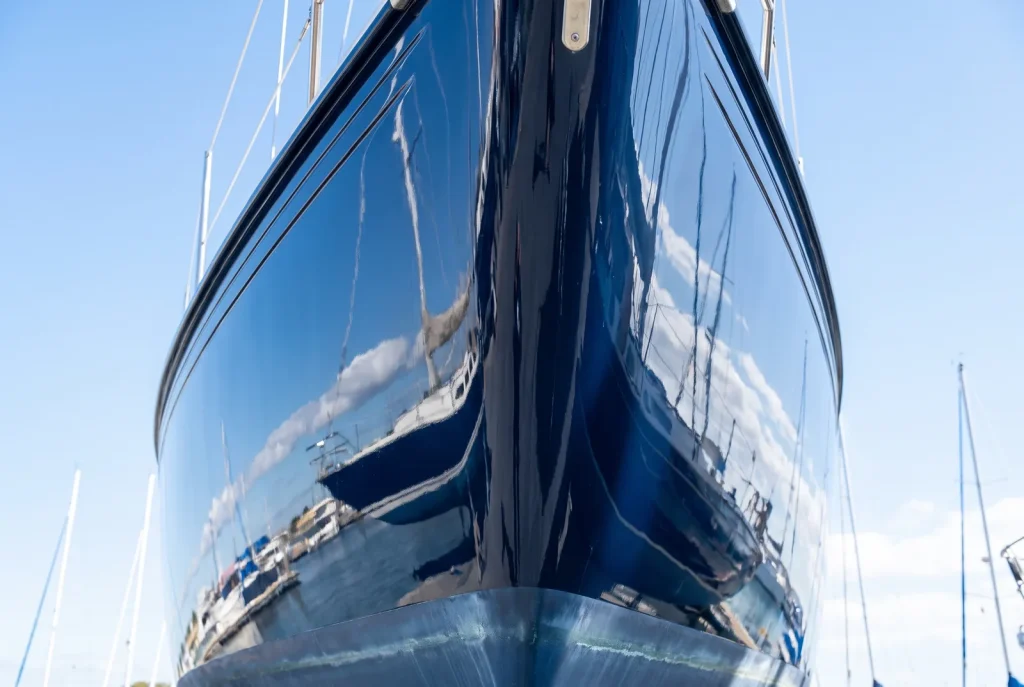 Restored glossy navy boat hull after oxidation removal detailing in O'Connor, WA