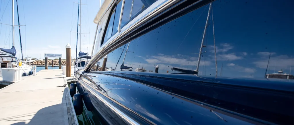 Oxidation removal result on a glossy navy boat hull, professional boat detailing in O'Connor