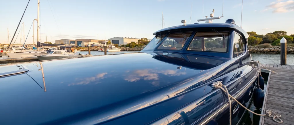 Mirror-smooth paint corrected blue boat hull from Shipshape Boat Detailing in O'Connor WA