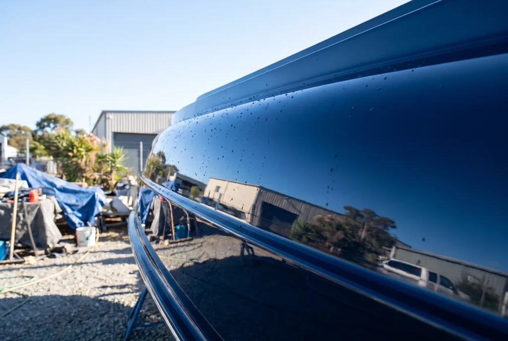 Paint correction result on navy boat hull, mirror gloss finish, Shipshape Boat Detailing O'Connor